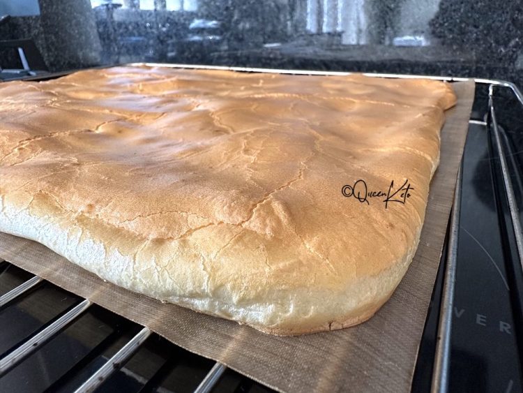 A sheet of golden zero-carb carnivore easy bread fresh from the oven on a baking mat