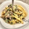 keto fettuccine with pancetta & mushrooms on a plate with a fork in it