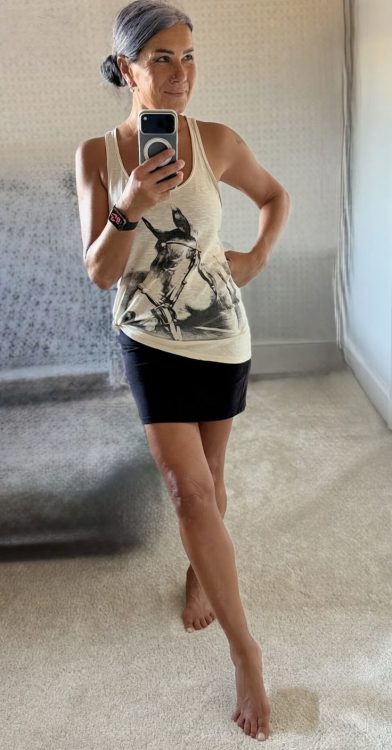 Antya taking a selfie through a mirror, clearly showing her legs.