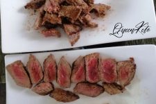 Two plates of seared steak, one sliced medium rare and one cut into crispy strips